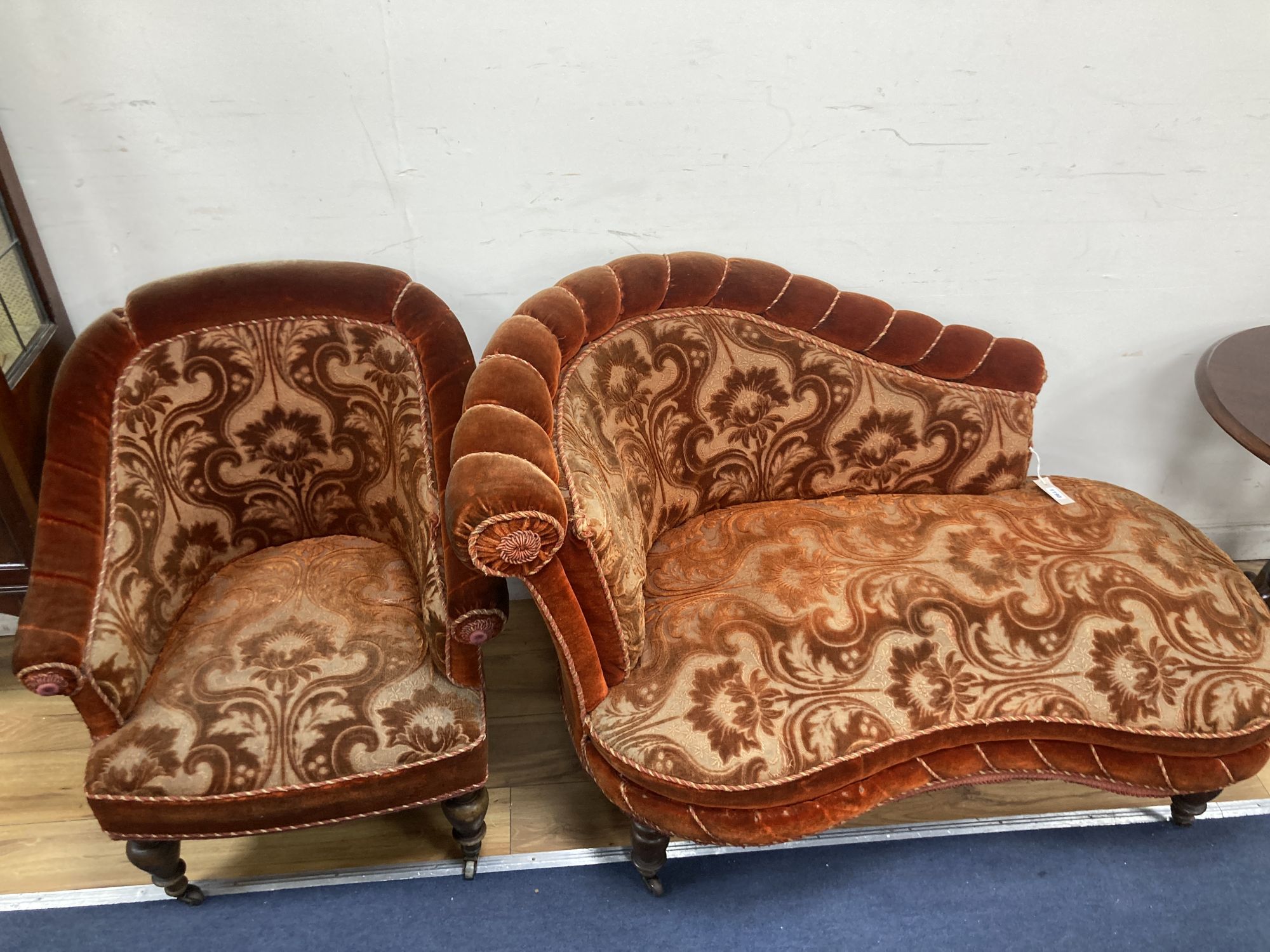 A small Victorian chaise longue, length 120cm, depth 80cm, height 84cm and matching tub framed armchair, each with cut red velvet uphol